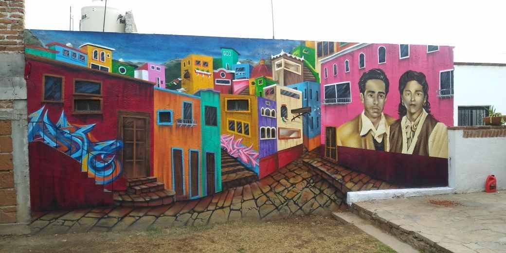 A mural of a man and buildings in the background.