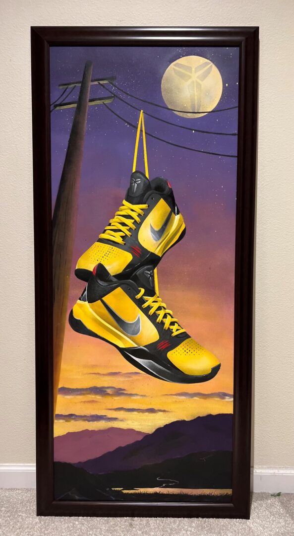 A painting of two yellow basketball shoes hanging from wires.