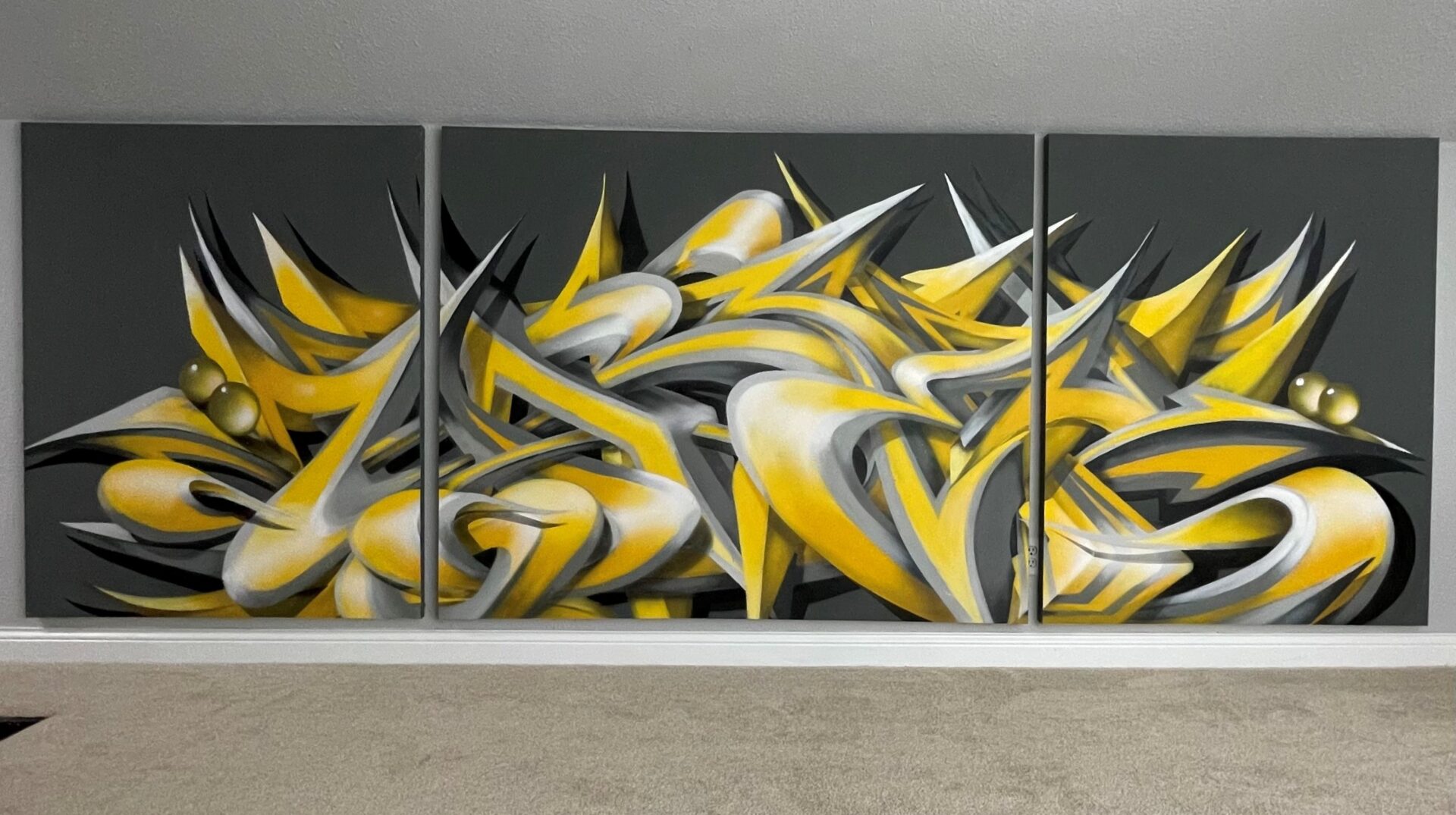 A wall with some yellow and white graffiti on it