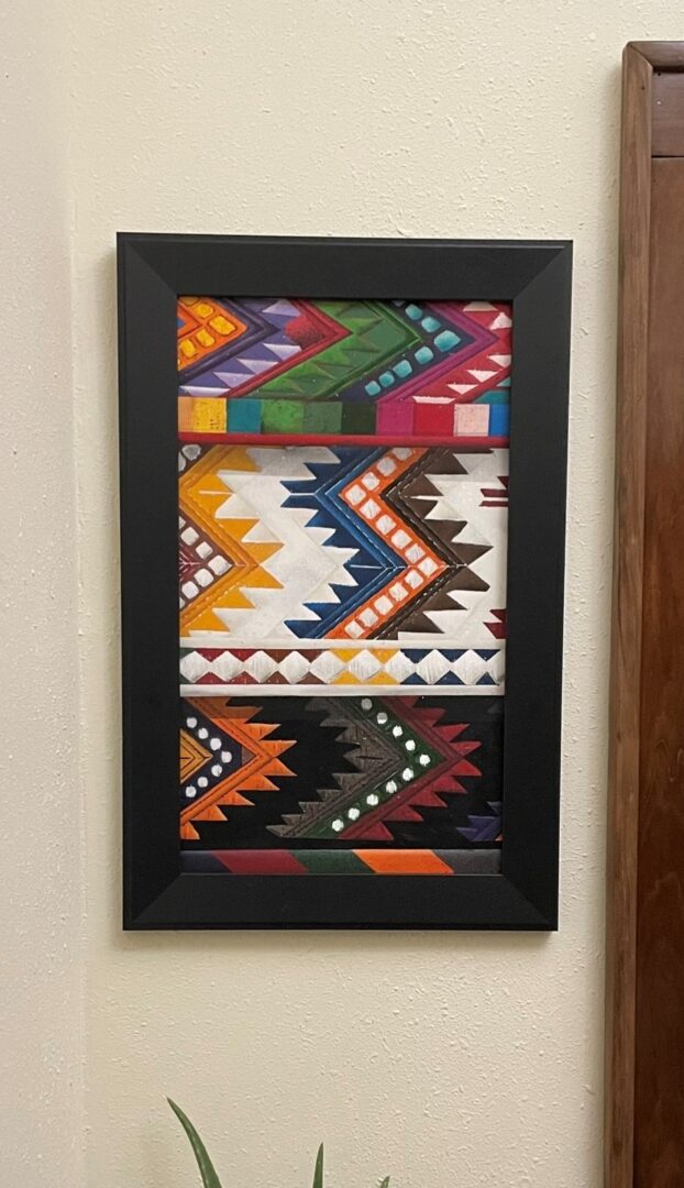 A picture of some colorful fabric on the wall.