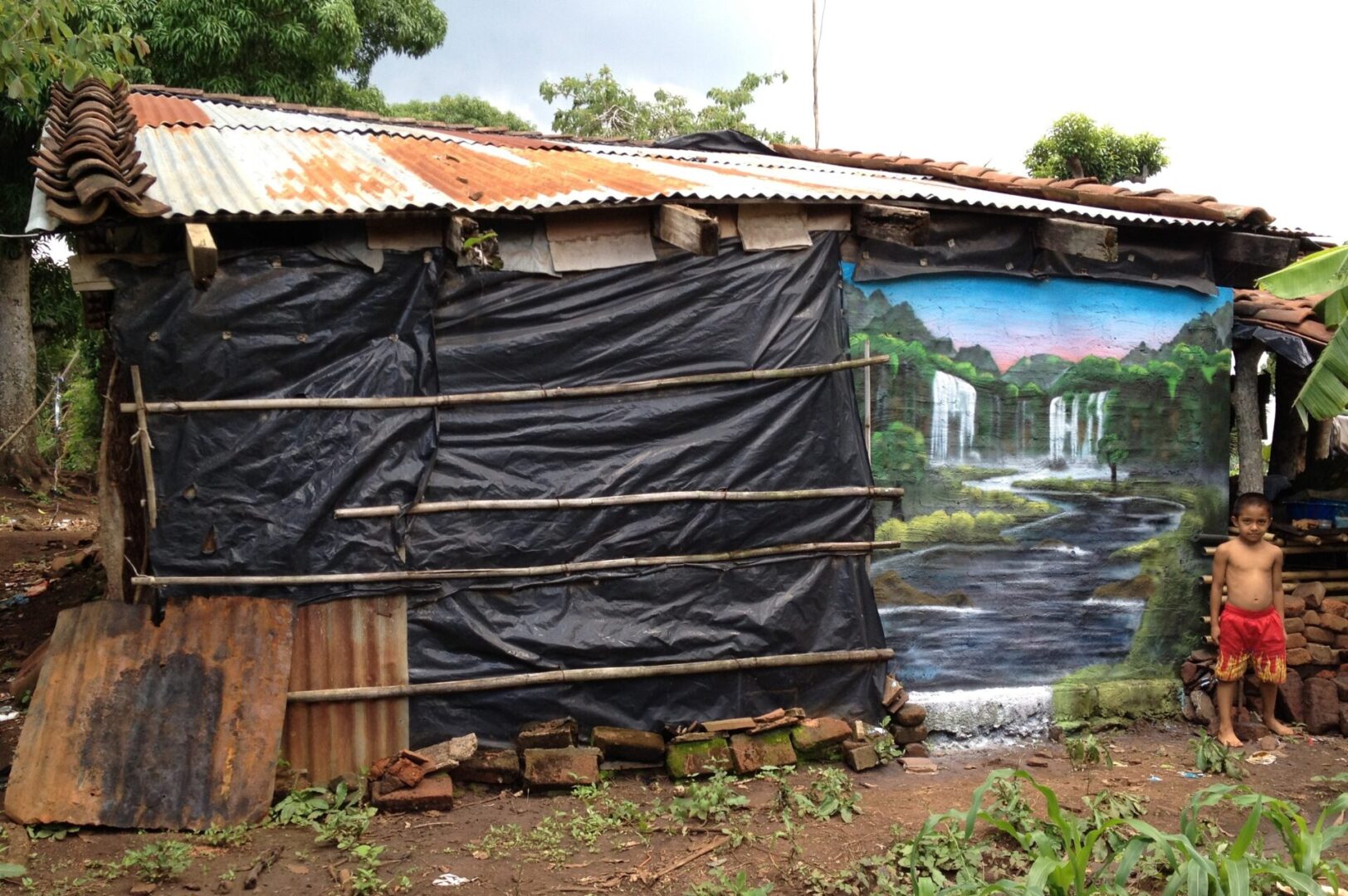 A black tarp covering the side of a building.