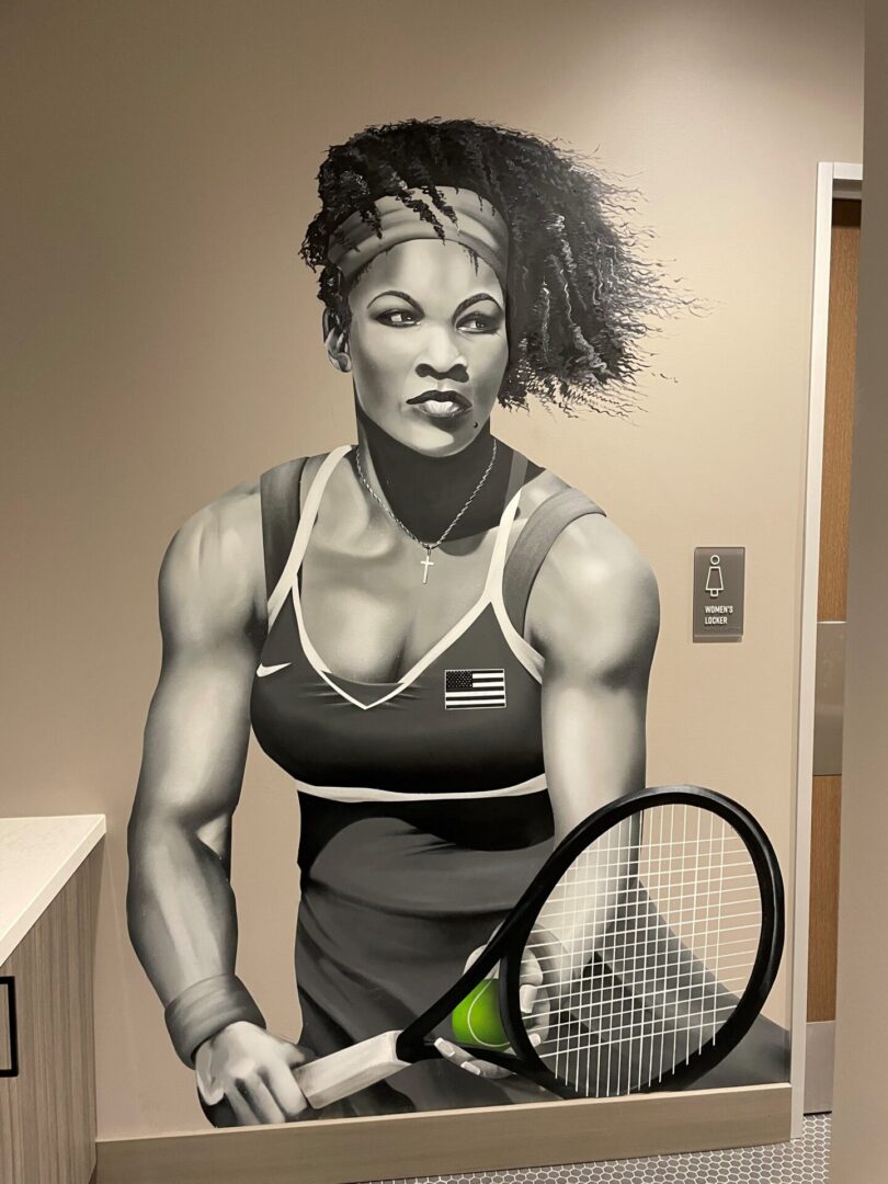 A mural of a woman holding a tennis racket.