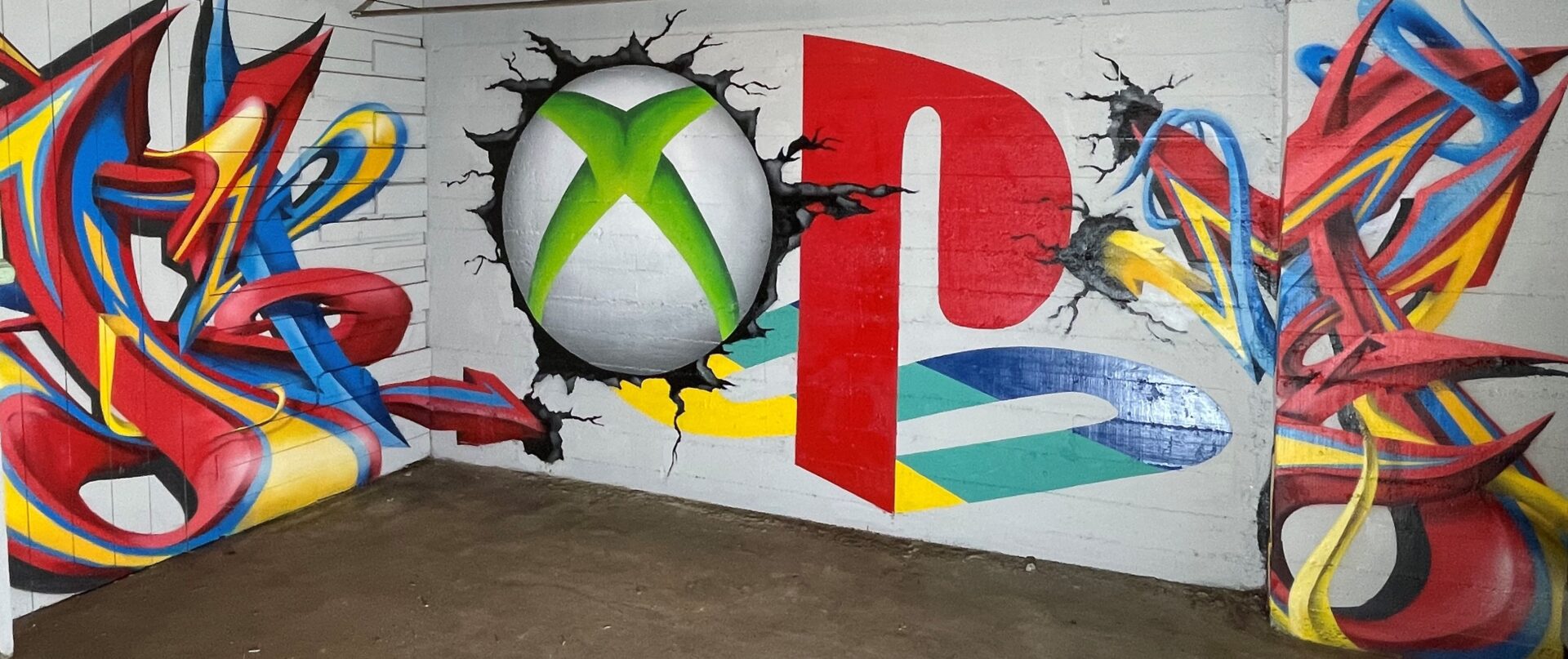 A wall with graffiti and a video game logo.