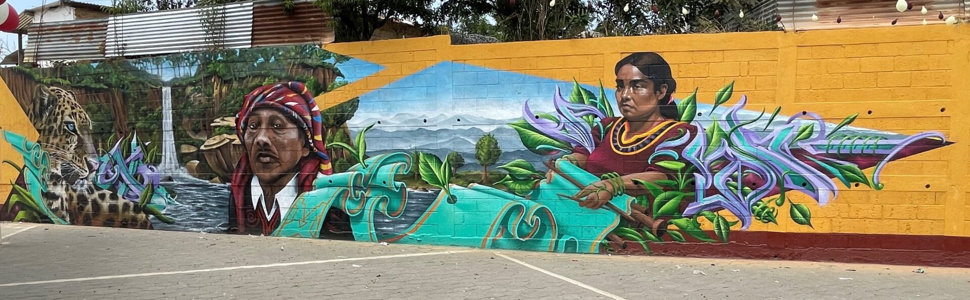 A mural of a woman with a surfboard in front of a beach.