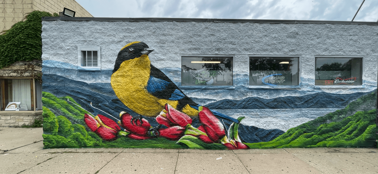 A mural of a bird on the side of a building.