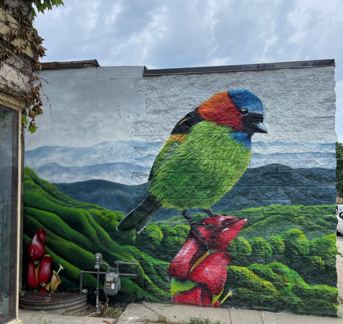 A mural of a bird on top of some strawberries.