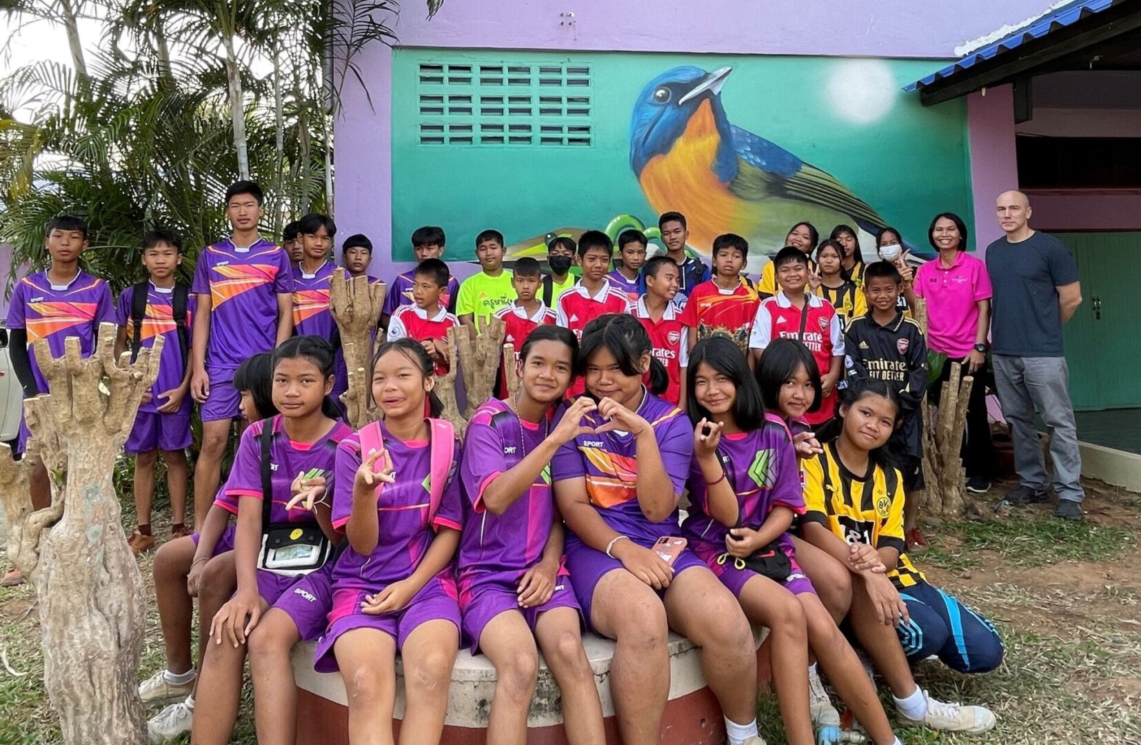 A group of children sitting on top of a bench.