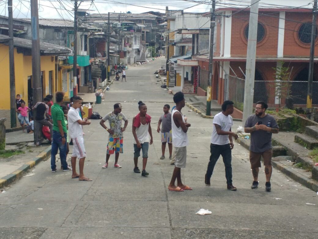 A group of people standing on the side walk