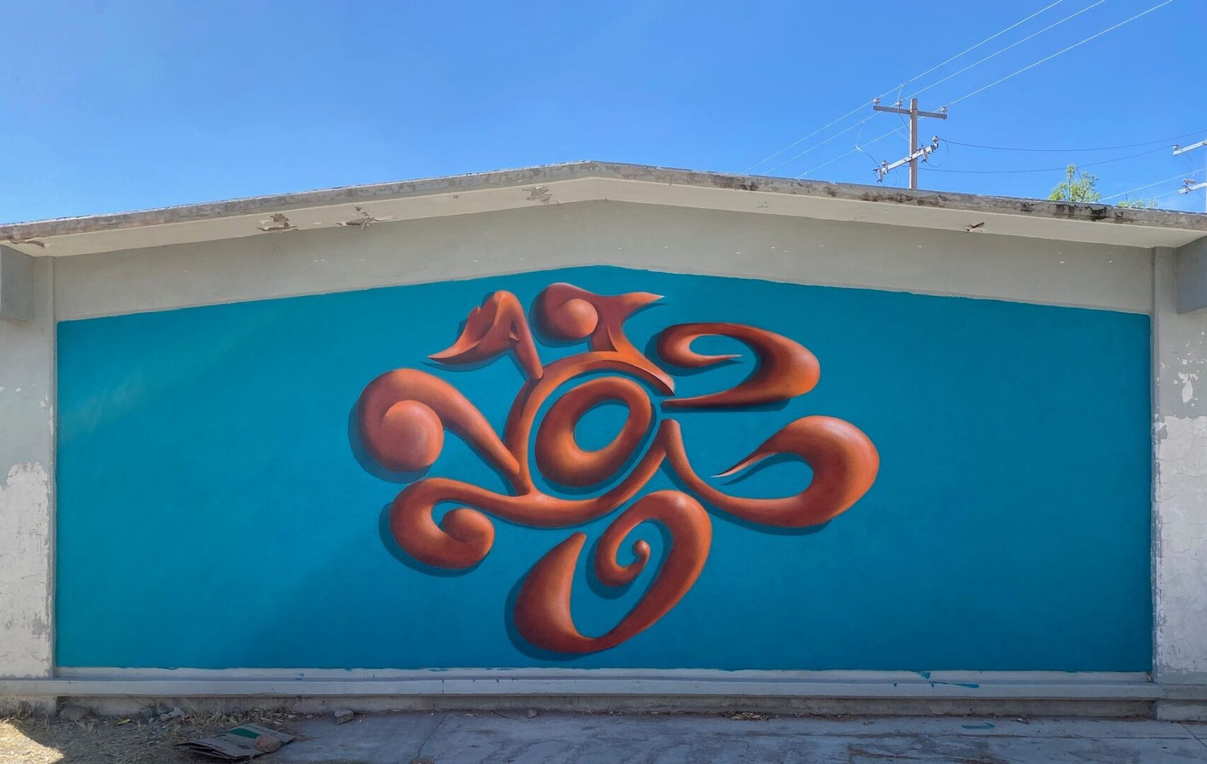 A mural of an abstract design on the side of a building.